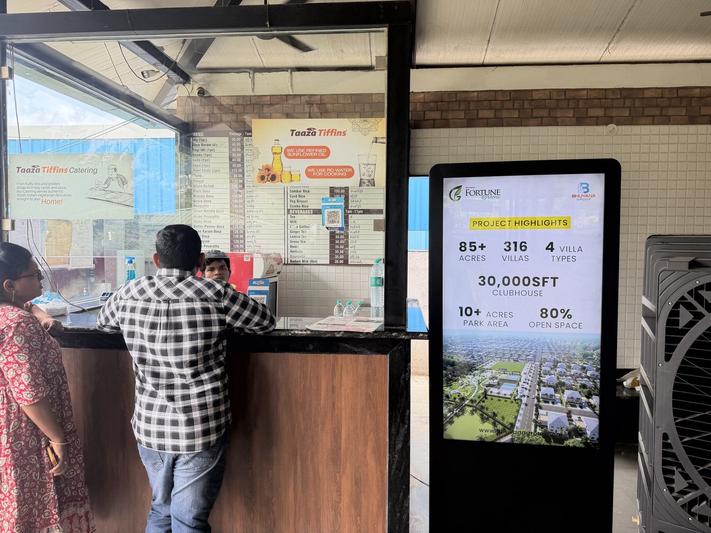 Real estate campaign playing on a KMEDIA screen at a restaurant